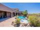 A freeform pool and spa are surrounded by desert landscaping and provide a relaxing backyard oasis at 8606 E Arroyo Seco Rd, Scottsdale, AZ 85266