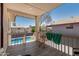 Cozy balcony with a view of the backyard pool and chair for relaxing and enjoying the outdoor scenery at 8829 W Sheridan St, Phoenix, AZ 85037