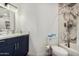 Well-lit bathroom featuring marble accents and a vanity at 8829 W Sheridan St, Phoenix, AZ 85037