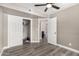 Spacious bedroom featuring closet, bathroom access, neutral paint, and wood-look floors at 8829 W Sheridan St, Phoenix, AZ 85037