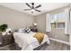 Cozy bedroom featuring a ceiling fan, light gray walls, and a comfortable bed with neutral decor at 8829 W Sheridan St, Phoenix, AZ 85037