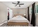 Bedroom with a ceiling fan, closet access, neutral paint, and a big window that brings in natural light at 8829 W Sheridan St, Phoenix, AZ 85037