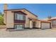 Beige two-story home with a well-maintained lawn and inviting entrance at 8829 W Sheridan St, Phoenix, AZ 85037