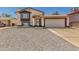Charming two-story home featuring a two-car garage and low-maintenance gravel landscaping at 8829 W Sheridan St, Phoenix, AZ 85037