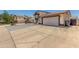 Exterior view of a two-story home featuring a spacious driveway and attached garage at 8829 W Sheridan St, Phoenix, AZ 85037
