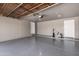 Spacious garage with epoxy flooring, white doors, and high ceilings offering ample space for parking and storage at 8829 W Sheridan St, Phoenix, AZ 85037