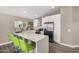 Modern kitchen featuring white cabinets, stainless steel appliances, and a quartz countertop island with seating at 8829 W Sheridan St, Phoenix, AZ 85037