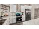 Bright kitchen features stainless steel appliances, white cabinetry, ample counter space, and updated fixtures at 8829 W Sheridan St, Phoenix, AZ 85037