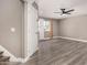 Spacious living room featuring stairs, neutral paint, wood-look floors, and a big window at 8829 W Sheridan St, Phoenix, AZ 85037