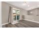 Open living room with sliding glass door and hardwood floors at 8829 W Sheridan St, Phoenix, AZ 85037