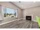 Comfortable living room featuring a decorative fireplace, neutral paint, and a big window with neighborhood views at 8829 W Sheridan St, Phoenix, AZ 85037