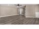Spacious living room featuring neutral paint, wood-look floors, and multiple access doors at 8829 W Sheridan St, Phoenix, AZ 85037