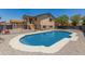 Private backyard with sparkling blue pool, gravel landscaping, and a black fence, ideal for summer fun at 8829 W Sheridan St, Phoenix, AZ 85037