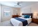 Comfortable bedroom with a large window, ceiling fan, and tasteful decor at 950 E Kelsi Ave, San Tan Valley, AZ 85140