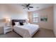 Comfortable bedroom with a large window, ceiling fan, and modern decor at 950 E Kelsi Ave, San Tan Valley, AZ 85140