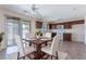 Cozy dining area showcasing a wooden table setting next to a bright, open kitchen space at 950 E Kelsi Ave, San Tan Valley, AZ 85140