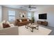 Comfortable living room with neutral colors, ceiling fan, and bright, natural lighting at 950 E Kelsi Ave, San Tan Valley, AZ 85140