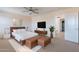 Spacious main bedroom suite with a king bed, seating, and an ensuite bathroom at 950 E Kelsi Ave, San Tan Valley, AZ 85140