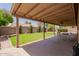 Inviting backyard with a covered patio, manicured lawn, and mature landscaping at 950 N Sailors Way, Gilbert, AZ 85234