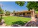 Expansive backyard featuring lush grass, a covered patio, and privacy fencing at 950 N Sailors Way, Gilbert, AZ 85234