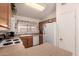 Well-lit kitchen with oak cabinets, white appliances, and tile flooring at 950 N Sailors Way, Gilbert, AZ 85234