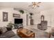 Comfortable living room with neutral colors, vaulted ceilings, a ceiling fan and tile flooring at 950 N Sailors Way, Gilbert, AZ 85234