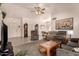 Spacious living room featuring neutral paint, vaulted ceilings, tile floors and comfortable furnishings at 950 N Sailors Way, Gilbert, AZ 85234