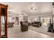 Spacious living room featuring tile floors, vaulted ceilings, a ceiling fan and a sliding glass door to the backyard at 950 N Sailors Way, Gilbert, AZ 85234