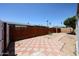 Backyard with paver walkway, gravel, and wooden fence at 10951 N 91St Ave # 16, Peoria, AZ 85345