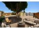 Large backyard features a shade tree, gravel landscaping, and outdoor seating areas at 10951 N 91St Ave # 16, Peoria, AZ 85345