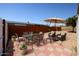 Back patio with checkered tile featuring a table and seating underneath an umbrella at 10951 N 91St Ave # 16, Peoria, AZ 85345