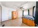 Bedroom with tile floors, ceiling fan, and large dresser provides comfort and storage at 10951 N 91St Ave # 16, Peoria, AZ 85345