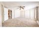 Spacious bedroom features carpet flooring, ceiling fan, and closet for ample storage space at 10951 N 91St Ave # 16, Peoria, AZ 85345
