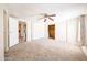 Spacious bedroom features carpet flooring, ceiling fan, and closet for ample storage space at 10951 N 91St Ave # 16, Peoria, AZ 85345
