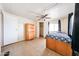 Bedroom with tile floors, ceiling fan, and closet provides comfort and storage at 10951 N 91St Ave # 16, Peoria, AZ 85345