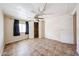 A bedroom with tile flooring and a closet at 10951 N 91St Ave # 16, Peoria, AZ 85345