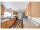 Galley kitchen with wood cabinets and stainless steel appliances at 10951 N 91St Ave # 16, Peoria, AZ 85345