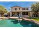 The backyard offers a pool with waterfall and covered patio perfect for gatherings at 11526 W Bermuda Dr, Avondale, AZ 85392