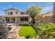 The expansive backyard features a pool, rock accents, grassy area, and covered patio at 11526 W Bermuda Dr, Avondale, AZ 85392