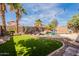 The landscaped backyard features a pool with a rock waterfall, plus an outdoor entertaining space at 11526 W Bermuda Dr, Avondale, AZ 85392