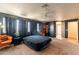 Bedroom features dark walls with orange accents, carpeted floor and a ceiling fan at 11526 W Bermuda Dr, Avondale, AZ 85392