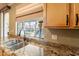 Kitchen sink with granite countertops and garden view, perfect for any home chef at 11526 W Bermuda Dr, Avondale, AZ 85392
