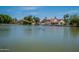 Scenic lake view surrounded by lush trees and lovely homes, creating a peaceful residential setting at 11526 W Bermuda Dr, Avondale, AZ 85392