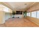 Bright and airy living room with large windows, plush carpet, and a ceiling fan at 11526 W Bermuda Dr, Avondale, AZ 85392