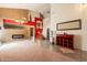 Bright living room with tile and carpet, a fireplace, staircase, and an elegant display at 11526 W Bermuda Dr, Avondale, AZ 85392