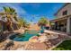 This backyard is an oasis with a sparkling pool, rock features, and lush landscaping at 11526 W Bermuda Dr, Avondale, AZ 85392