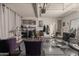 Spacious converted garage into a salon with chairs, shelving and curtains at 11526 W Bermuda Dr, Avondale, AZ 85392
