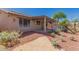 Desert landscaped backyard featuring a covered patio, offering a serene outdoor living space at 11543 W Sandsnake Ct, Surprise, AZ 85378