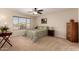 Comfortable bedroom features a ceiling fan and large window offering natural light and desert views at 11543 W Sandsnake Ct, Surprise, AZ 85378