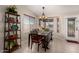 Charming dining area features a decorative chandelier and shelving, with window views at 11543 W Sandsnake Ct, Surprise, AZ 85378